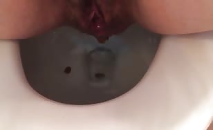 Hairy babe shitting in close up