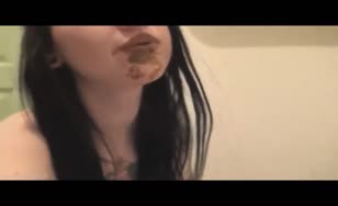 Dark haired teen smear shit on entire face