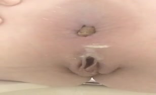 Shaved girl pooping over toilet