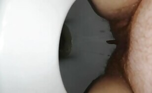 Hairy babe shits big ones over toilet