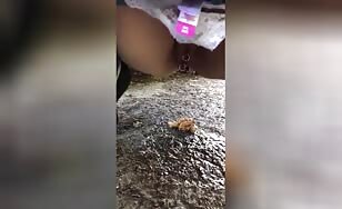 Sexy lady poops hard in the grass 