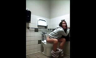 Nasty girl teasing and pooping in the public toilet 